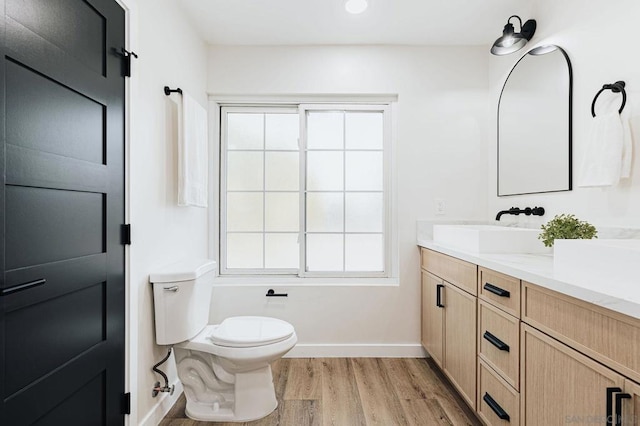 bathroom featuring hardwood / wood-style floors, toilet, and vanity