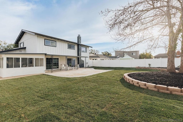 back of property featuring a lawn and a patio