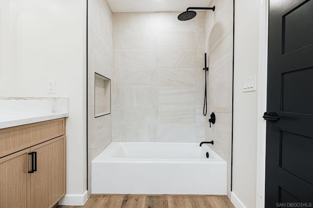 bathroom featuring vanity, tiled shower / bath, and hardwood / wood-style floors