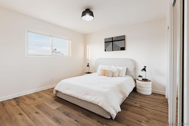 bedroom with hardwood / wood-style flooring