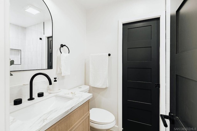 bathroom with toilet and vanity