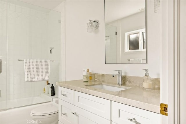 full bathroom featuring toilet, vanity, and shower / bath combination with glass door