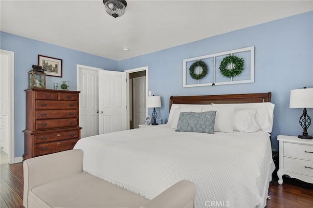 bedroom with a closet and dark hardwood / wood-style floors