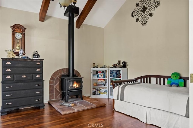 bedroom with dark wood-type flooring, a wood stove, and vaulted ceiling with beams