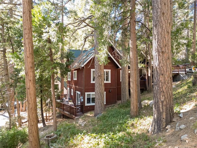 view of property exterior with a deck