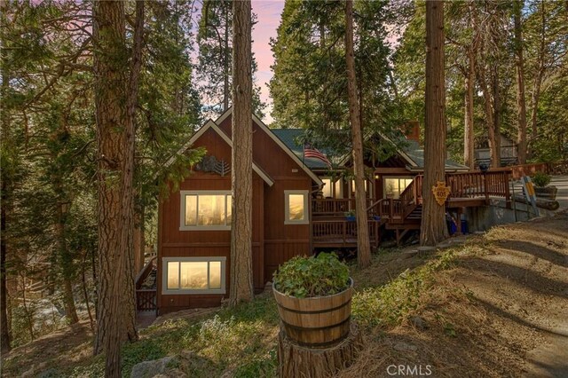 back house at dusk with a deck