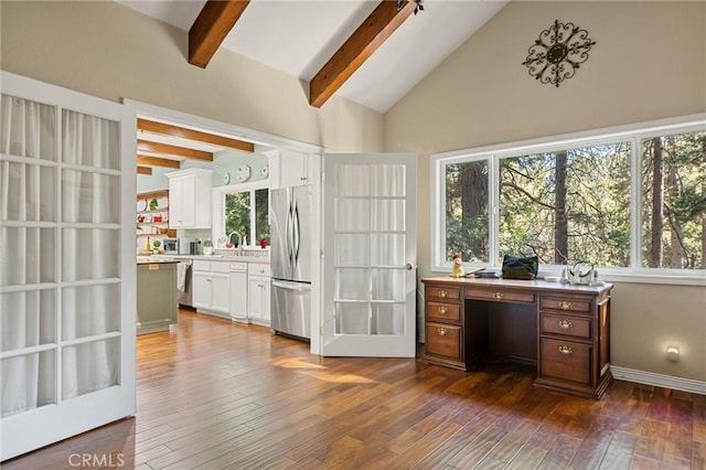 home office with dark hardwood / wood-style flooring, vaulted ceiling with beams, and sink