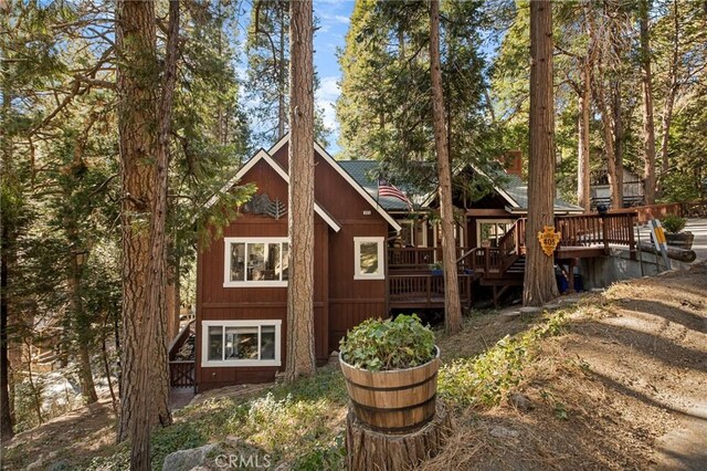 back of property featuring a wooden deck