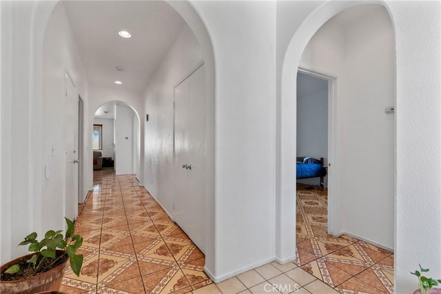 hall with light tile patterned floors