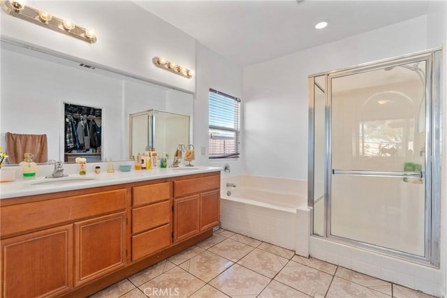 bathroom featuring tile patterned flooring, plus walk in shower, and vanity