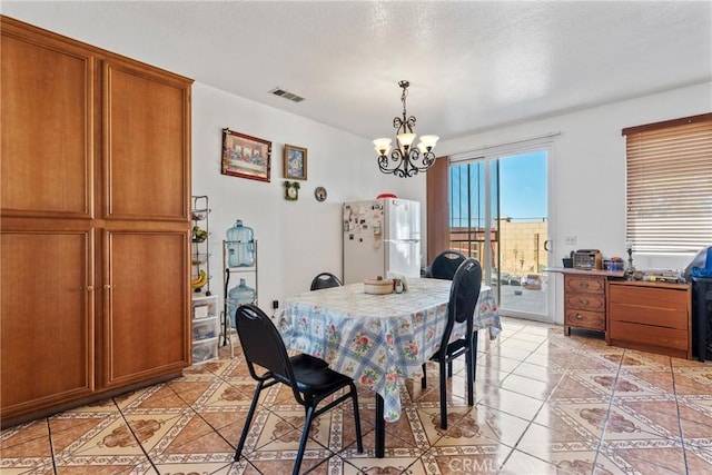 dining space featuring an inviting chandelier and light tile patterned flooring