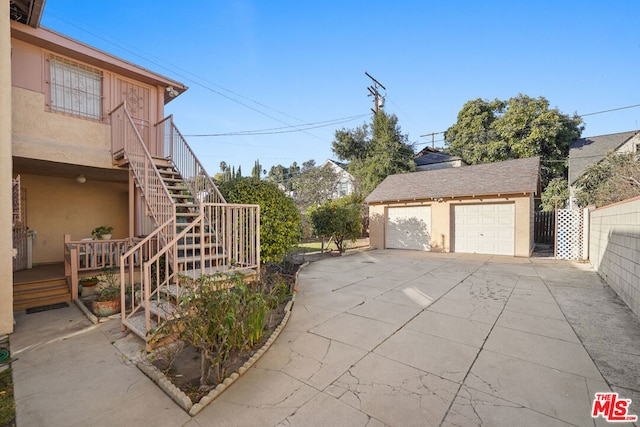 view of side of property featuring a garage and an outbuilding