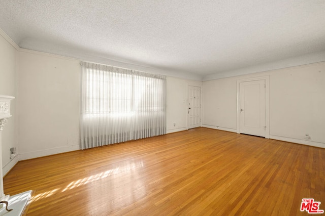 interior space featuring a textured ceiling and light wood-type flooring