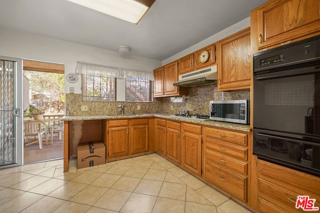 kitchen with light tile patterned flooring, sink, gas stovetop, tasteful backsplash, and black double oven