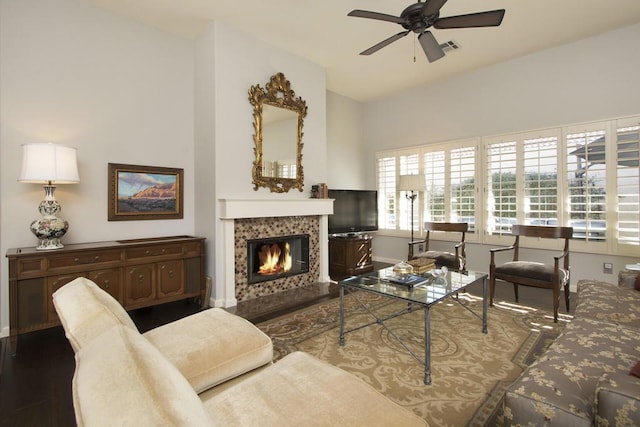 living room with wood-type flooring, a fireplace, and ceiling fan