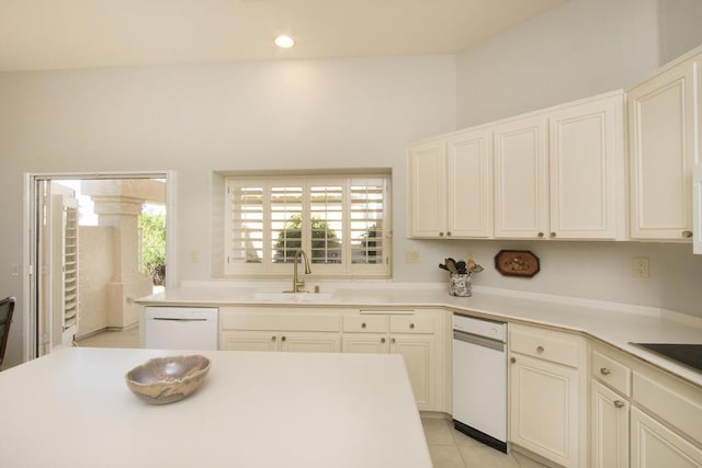 kitchen featuring dishwasher, sink, a wealth of natural light, and light tile patterned floors