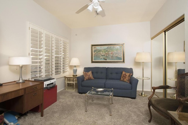 carpeted living room with ceiling fan