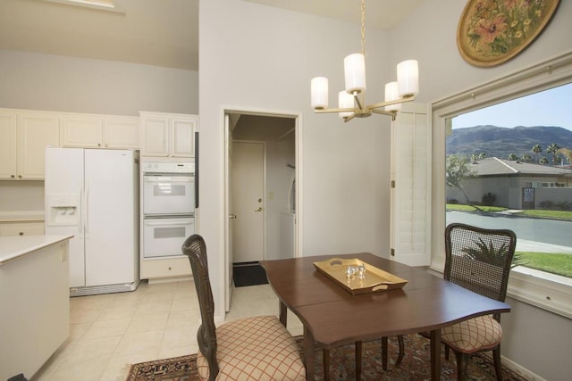 dining space featuring an inviting chandelier and a mountain view