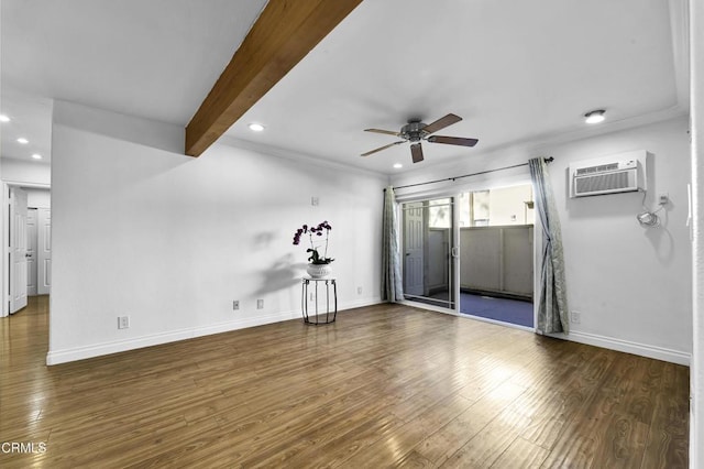 spare room featuring ceiling fan, an AC wall unit, dark wood-type flooring, and beamed ceiling