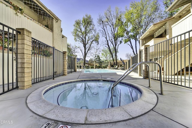 view of pool with a community hot tub