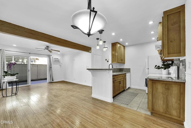 kitchen with ceiling fan, a wall mounted air conditioner, decorative light fixtures, beam ceiling, and sink