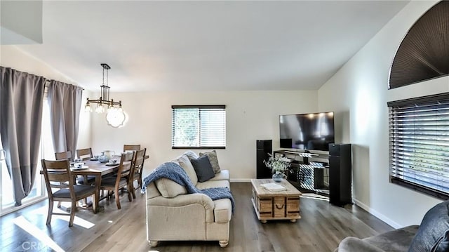 living room with wood-type flooring and an inviting chandelier