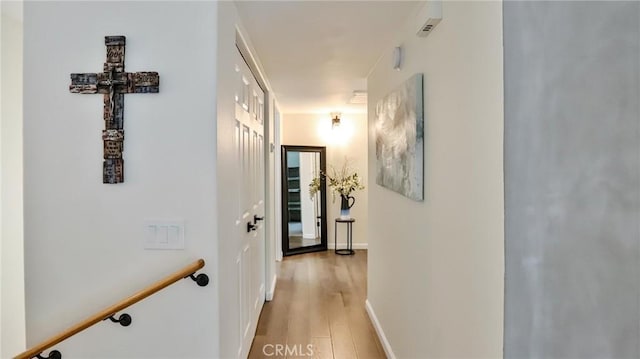 hallway with light hardwood / wood-style flooring