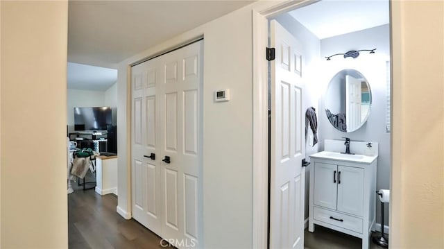 hall featuring dark hardwood / wood-style flooring and sink