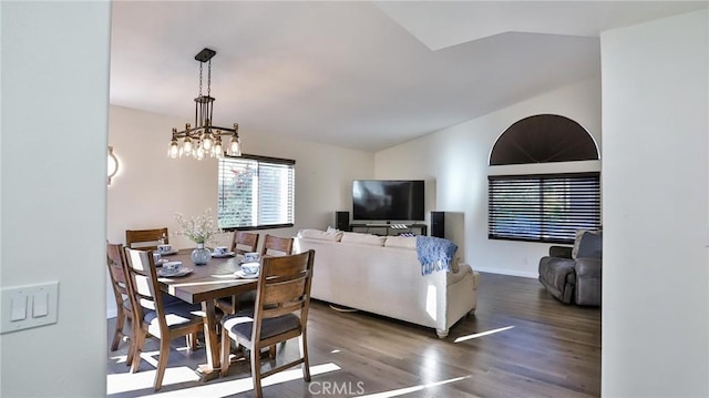 dining space featuring vaulted ceiling, dark hardwood / wood-style floors, and a notable chandelier