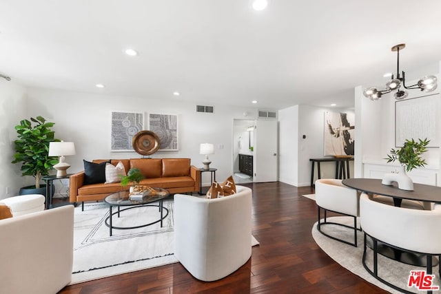 living room with a chandelier and dark hardwood / wood-style floors