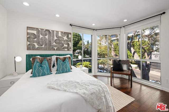 bedroom with dark wood-type flooring