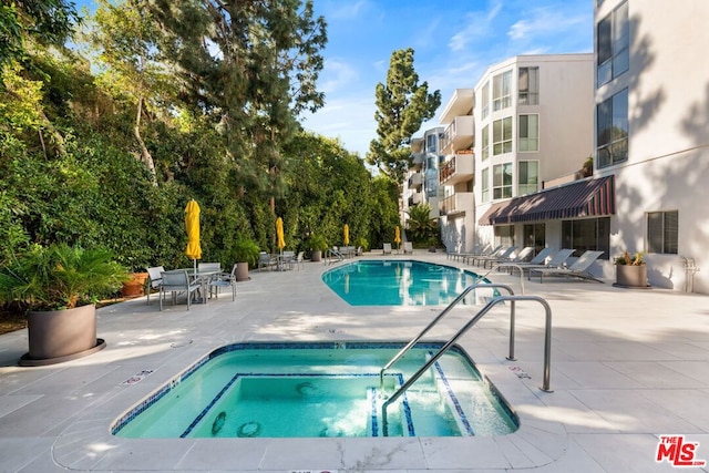 view of pool with a patio area and a community hot tub