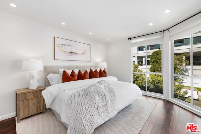 bedroom with hardwood / wood-style flooring