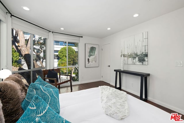 bedroom with dark hardwood / wood-style flooring