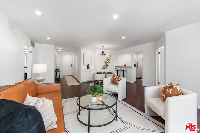 living room featuring light hardwood / wood-style flooring and a chandelier