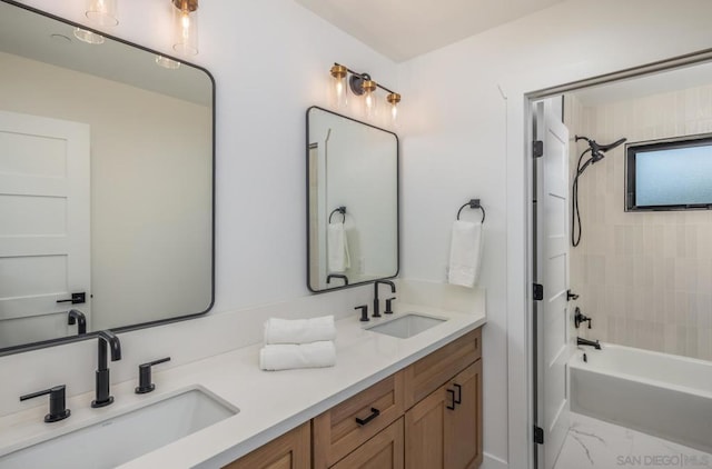 bathroom with tiled shower / bath and vanity