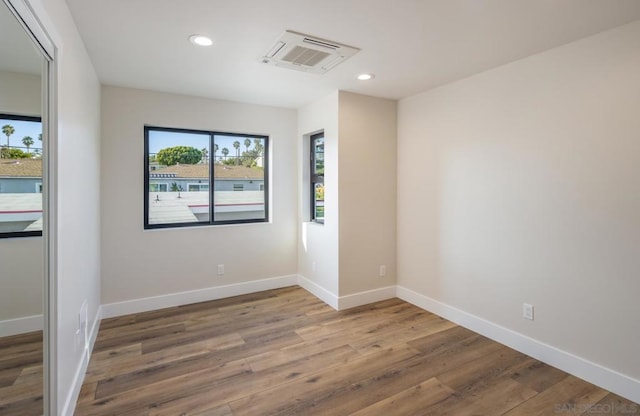 unfurnished room featuring wood-type flooring