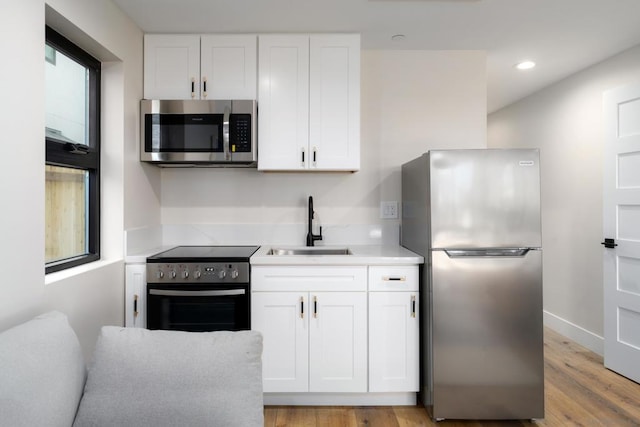 kitchen featuring sink, white cabinetry, and appliances with stainless steel finishes