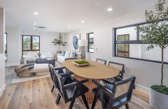 dining space with light hardwood / wood-style floors