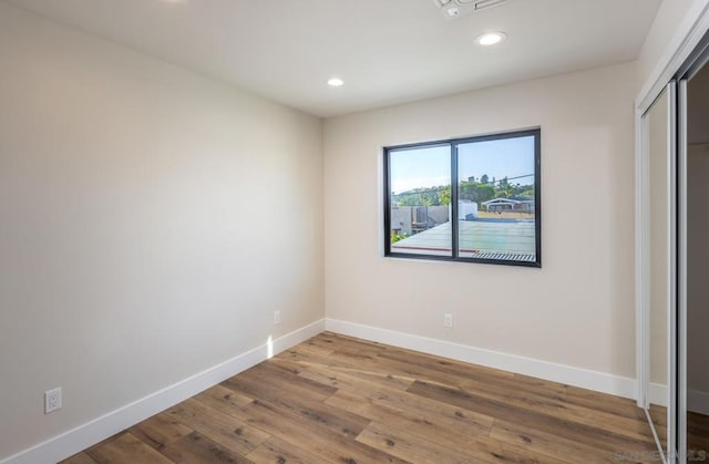 unfurnished bedroom featuring wood-type flooring and a closet