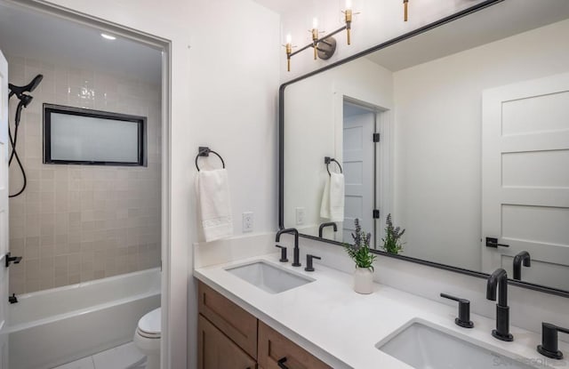 full bathroom with toilet, vanity, tiled shower / bath combo, and tile patterned floors