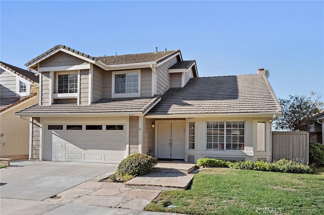 view of front of property featuring a front yard and a garage