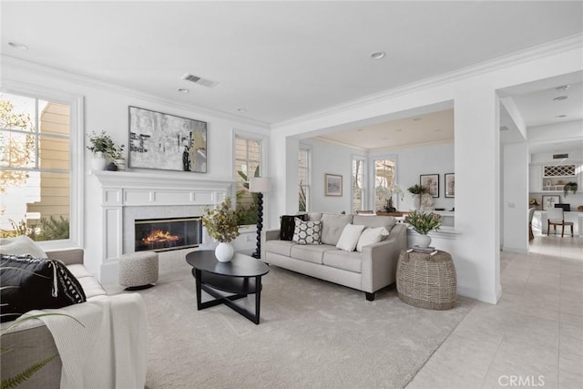 living room featuring crown molding, plenty of natural light, and light tile patterned floors