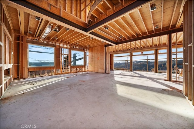 miscellaneous room with a mountain view and concrete flooring