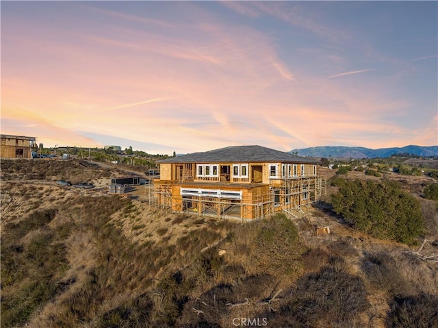 back house at dusk featuring a mountain view