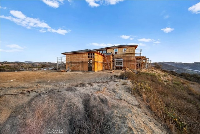 view of outdoor structure featuring a rural view and a mountain view