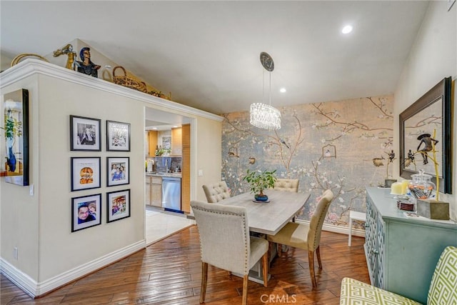 dining area with wood-type flooring and vaulted ceiling