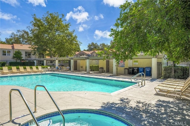 view of pool with a community hot tub and a patio area