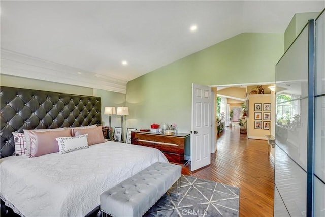 bedroom with hardwood / wood-style flooring and lofted ceiling