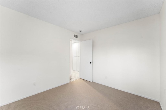 unfurnished room with light colored carpet